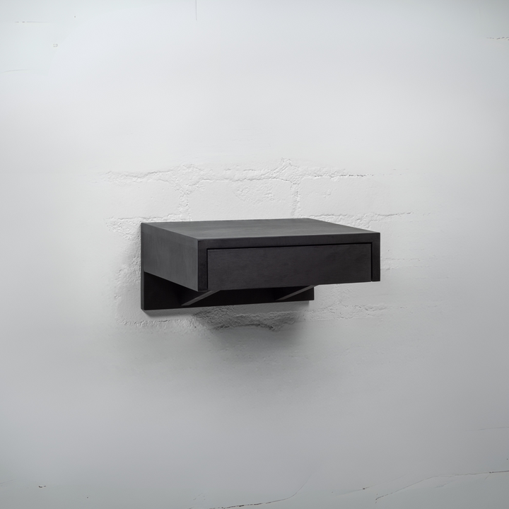 A black wooden nightstand with an open drawer revealing spacious storage for organizing bedroom essentials
