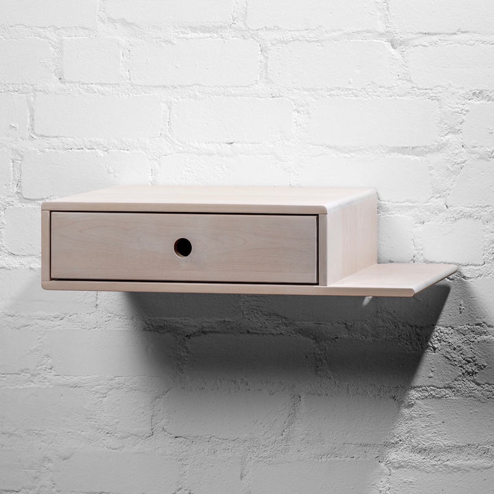 Wooden nightstand with a functional drawer, paired with an extended side shelf for additional storage