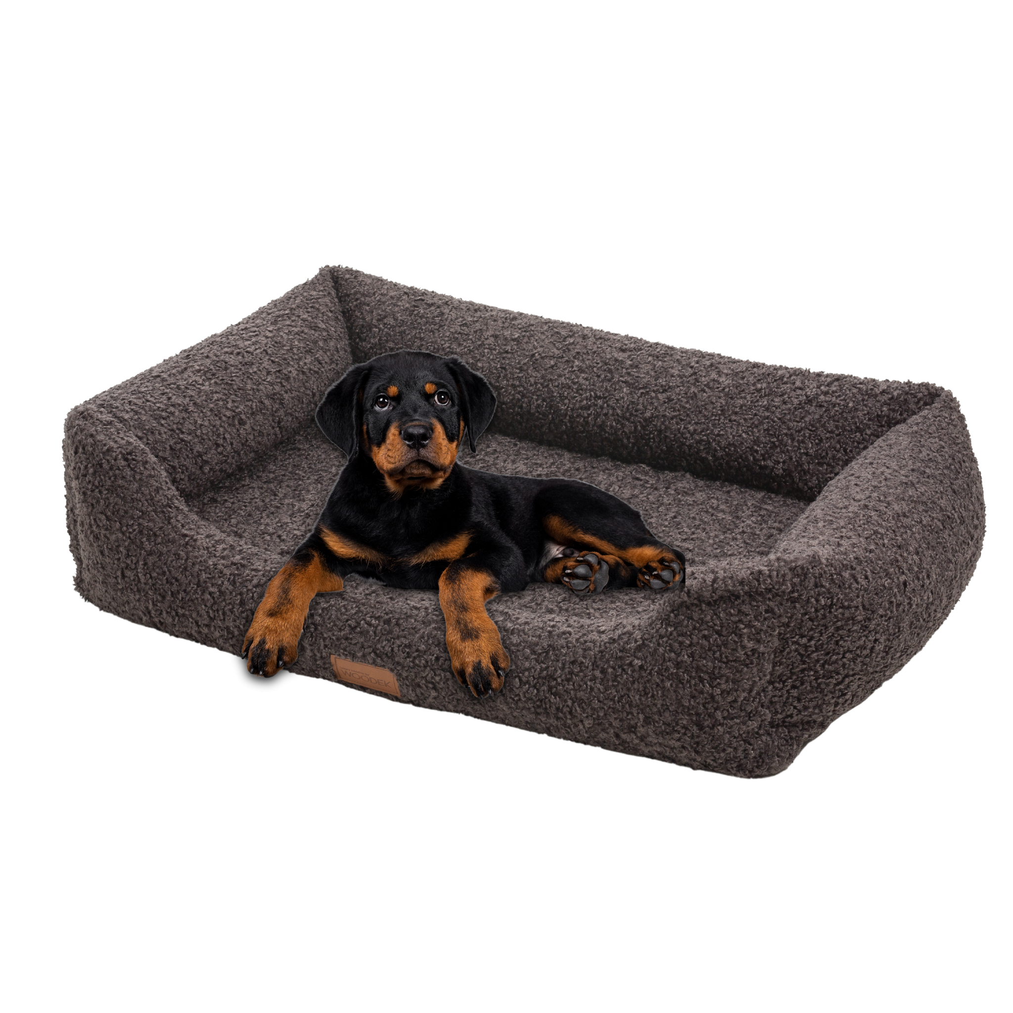 Black and tan puppy resting on a gray orthopedic dog bed, designed for ultimate comfort and support for joints.