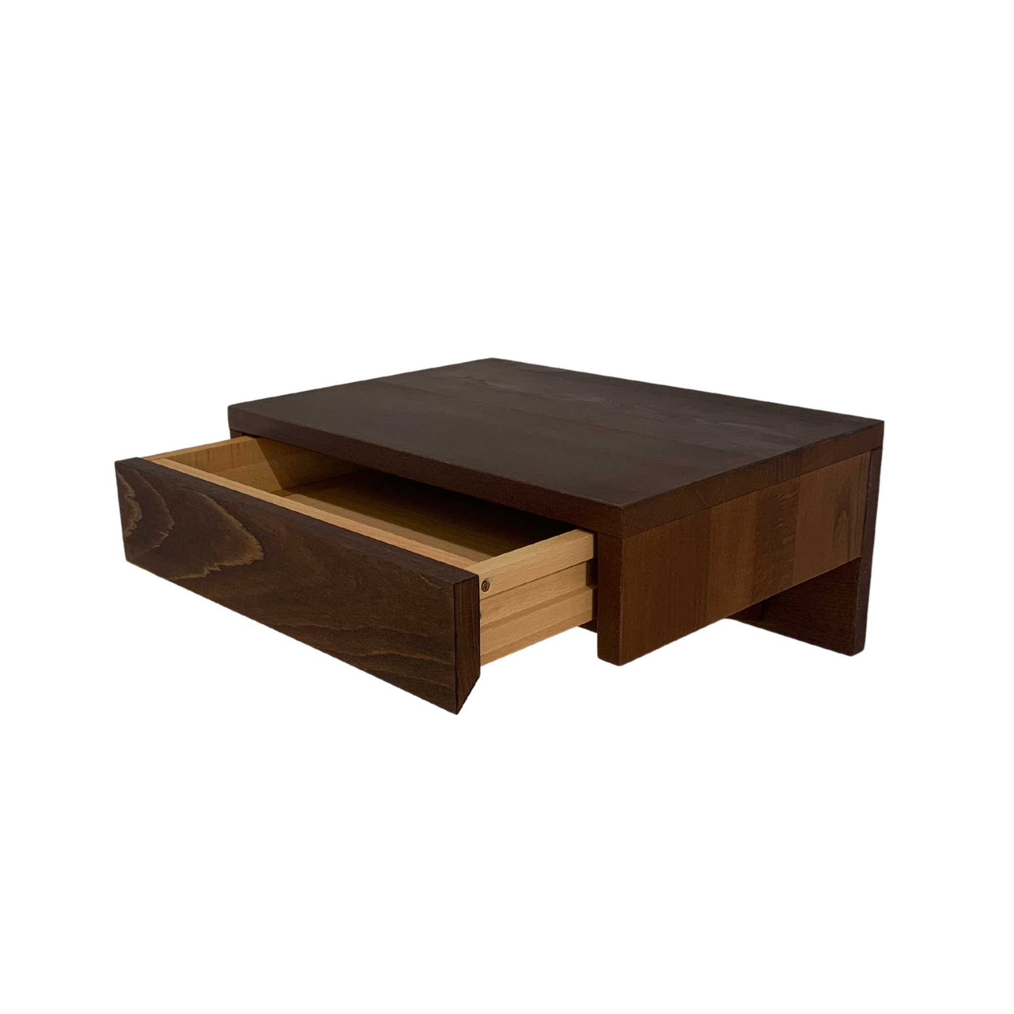 A modern bedside table with a drawer, mounted on the wall for a space-saving solution