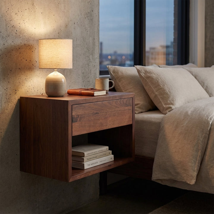 Evening bedroom lifestyle - Hugo solid walnut floating nightstand with drawer and open shelf, styled with lamp beside bed