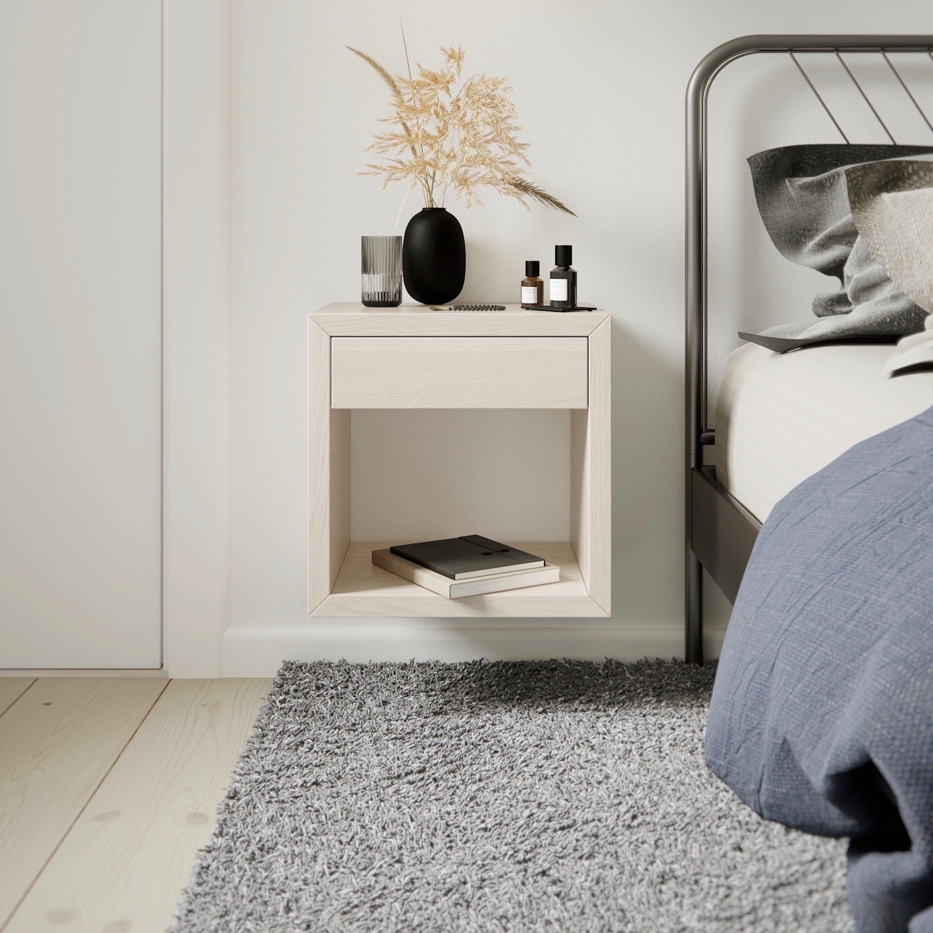 The small nightstand is finely crafted in solid birch wood with a white finish. With a minimal style it shows the beauty of the natural grain of the wood.