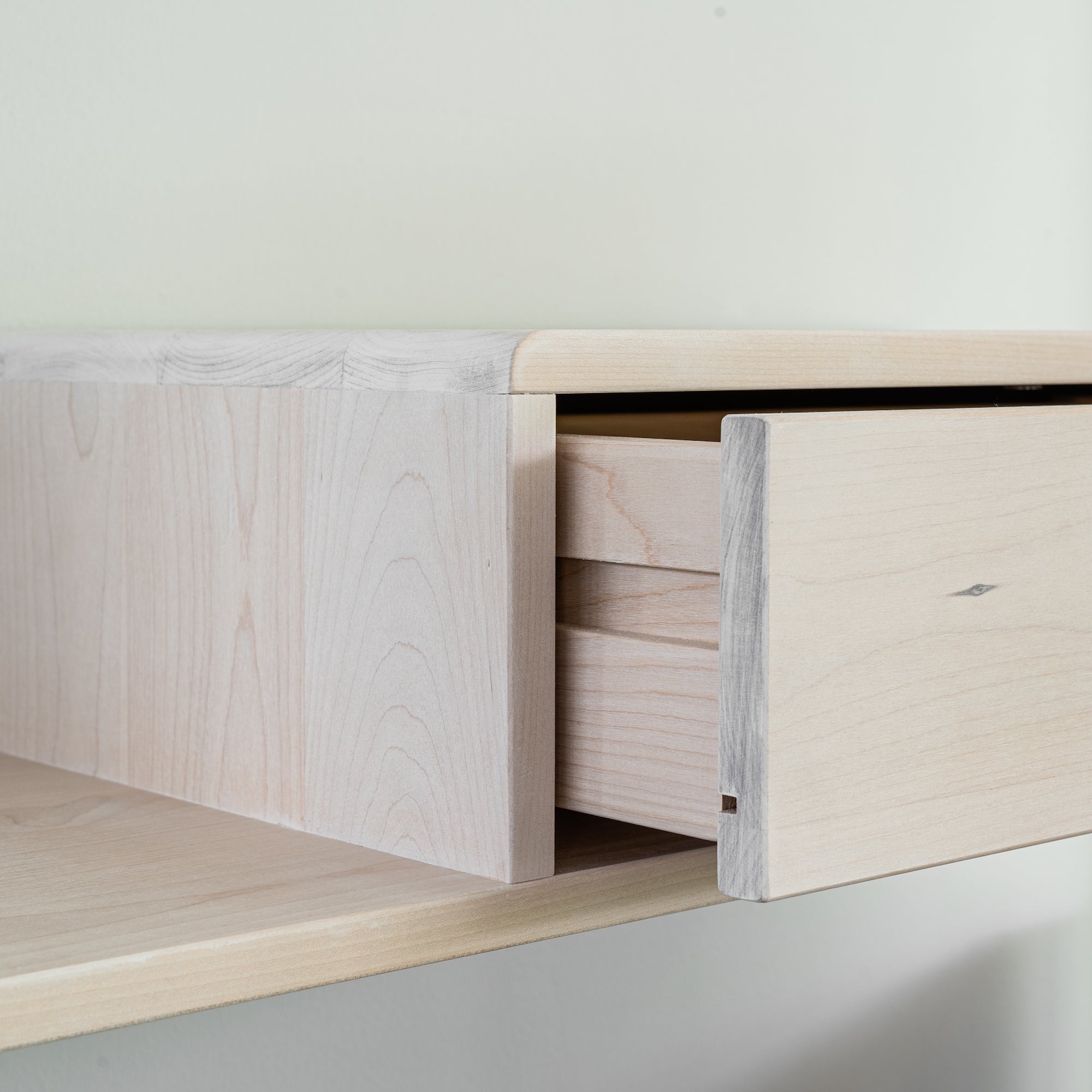 Modern nightstand crafted from wood, designed with a push-to-open drawer for seamless usability