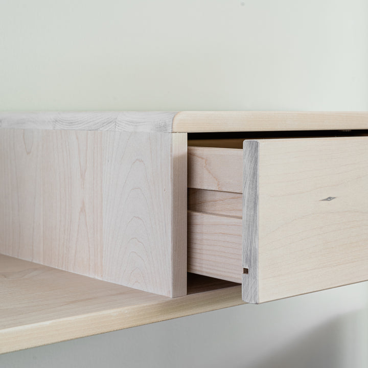 Modern nightstand crafted from wood, designed with a push-to-open drawer for seamless usability