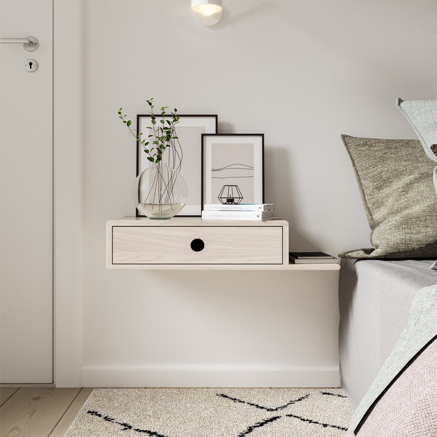 Floating nightstand mounted on a white wall, featuring a single drawer with a minimalist black finish