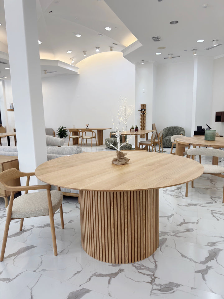 Handcrafted American oak round dining table with smooth surface and rustic warmth