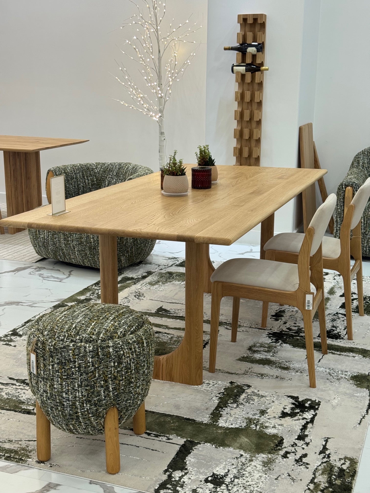 Minimal oak pouf with soft green upholstered seat and natural grain legs