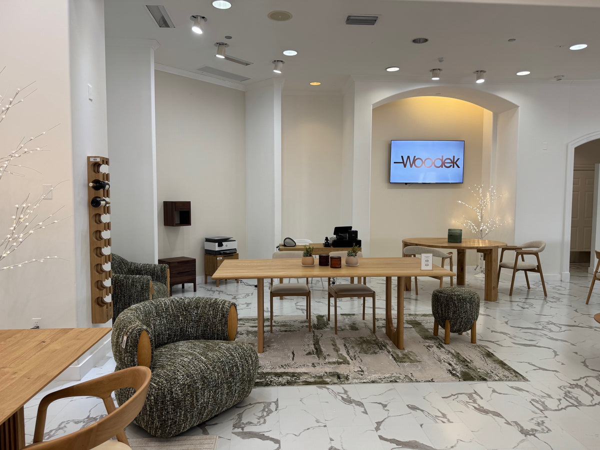 Scandinavian design showroom with natural oak tables, textured armchairs, marble-effect floor, and illuminated archway, Bocas1 gallery 1