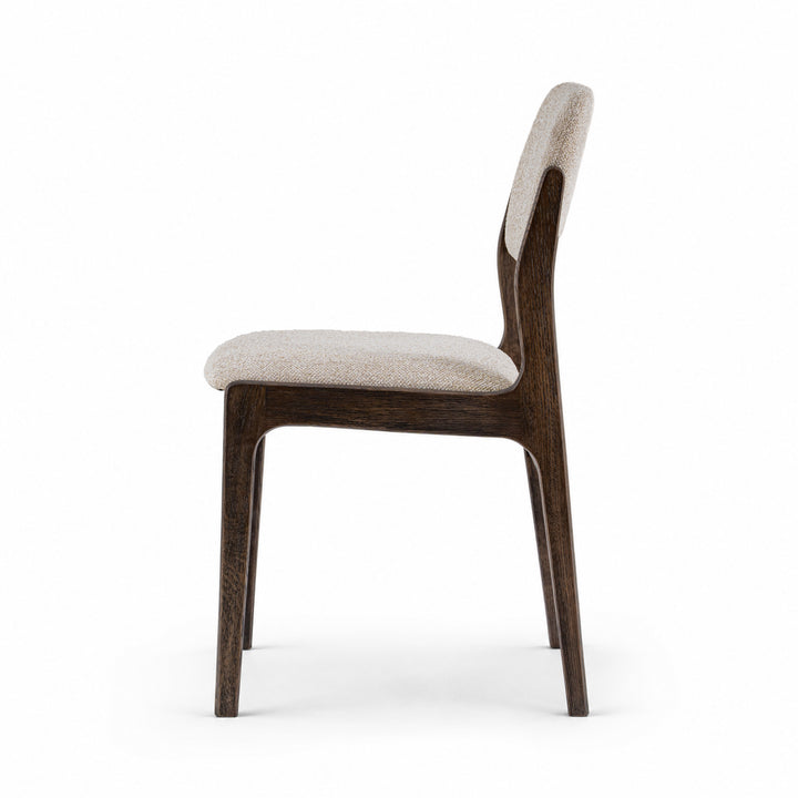 A modern dining chair with a dark brown wooden frame and light beige textured upholstery on the seat and backrest, shown from a side profile view against a solid white background.
