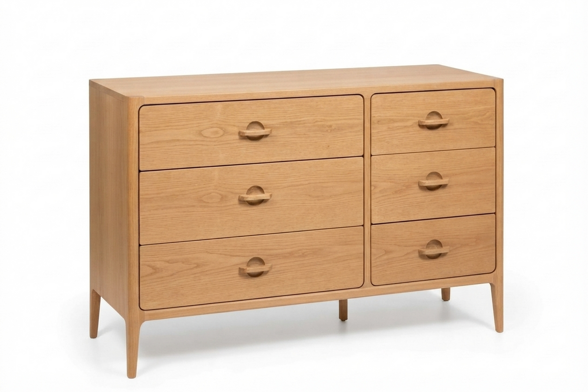A mid-century modern wooden dresser with six drawers in a light oak finish, featuring small round drawer pulls and tapered legs, shown on a white background.