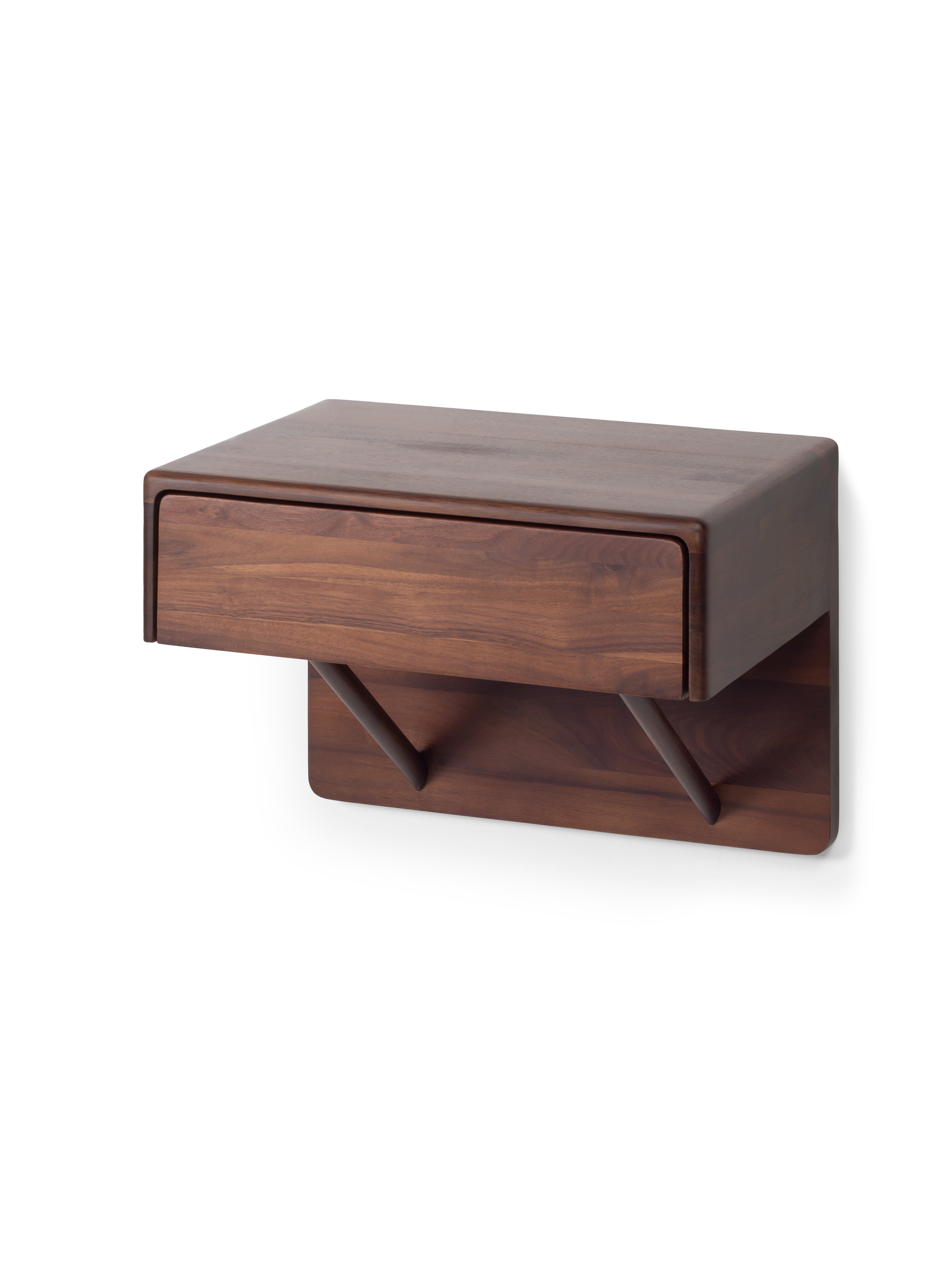 Wooden wall-mounted shelf with a drawer on a white background