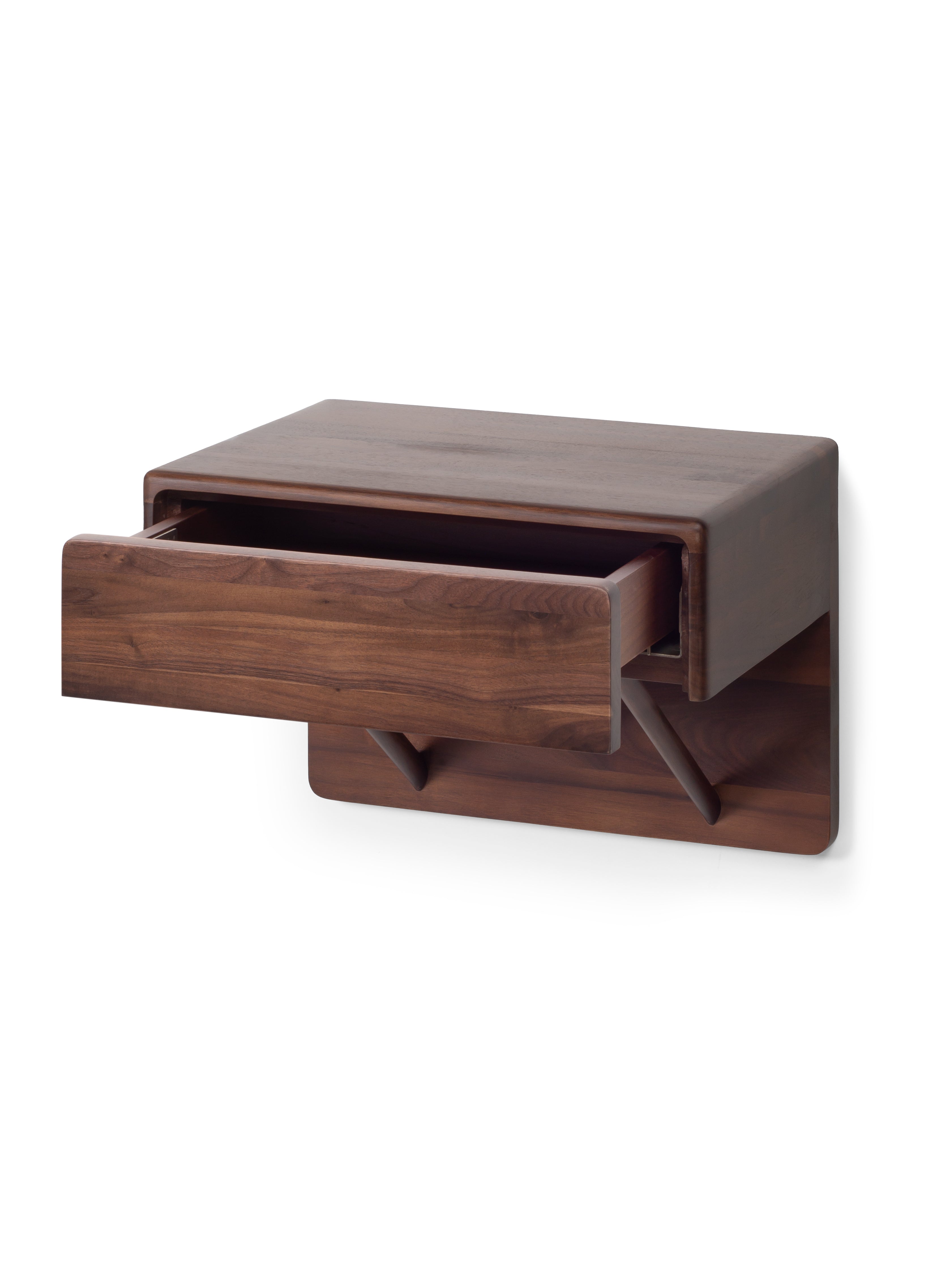 Wooden wall-mounted shelf with a drawer on a white background