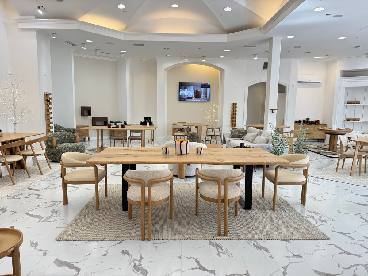 Spacious Scandinavian-inspired room with solid oak dining tables, mixed seating styles, and neutral rugs under modern vaulted ceiling IMG_8449.heic