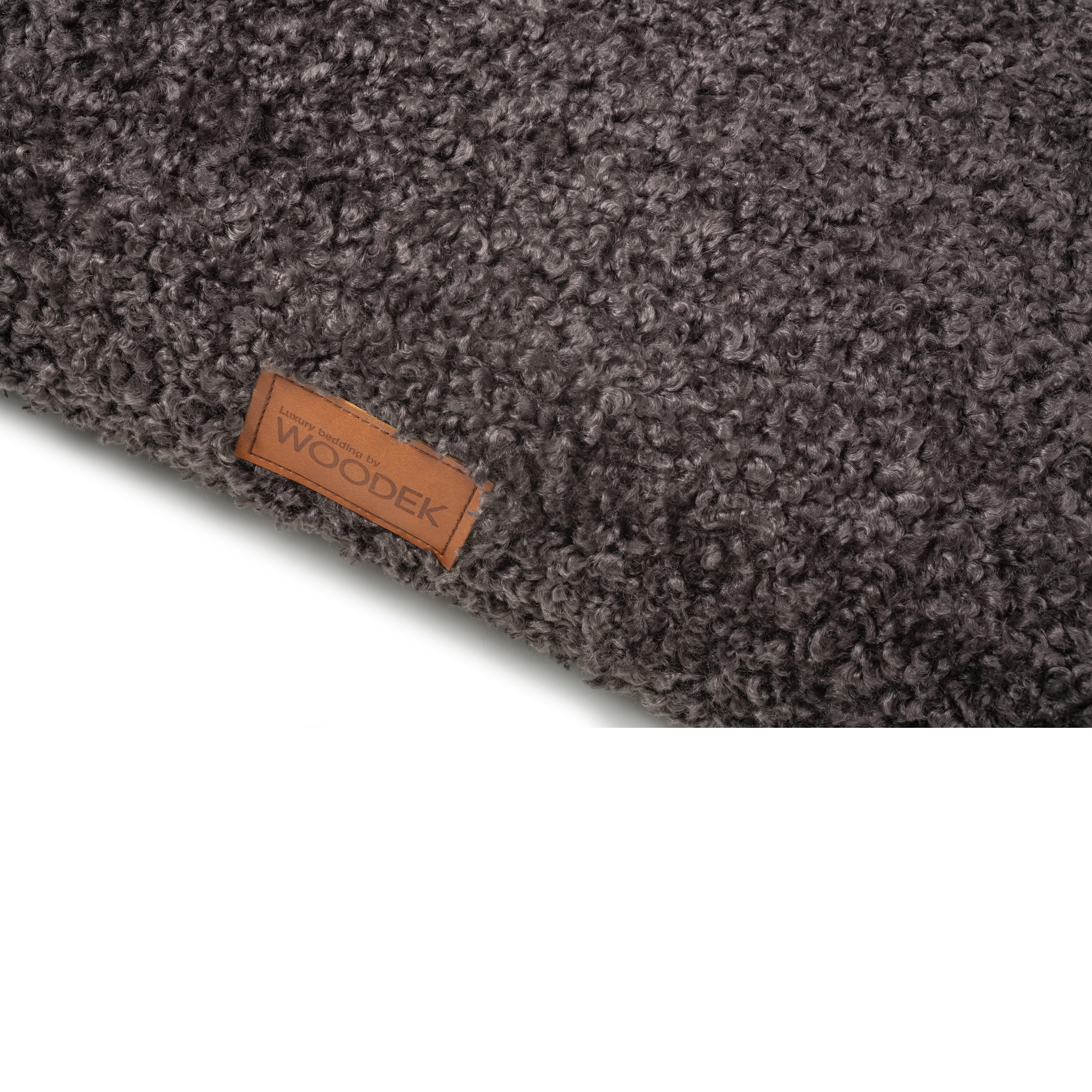 Close-up of the soft textured surface and luxury branding on a gray pet mattress by Woodek.