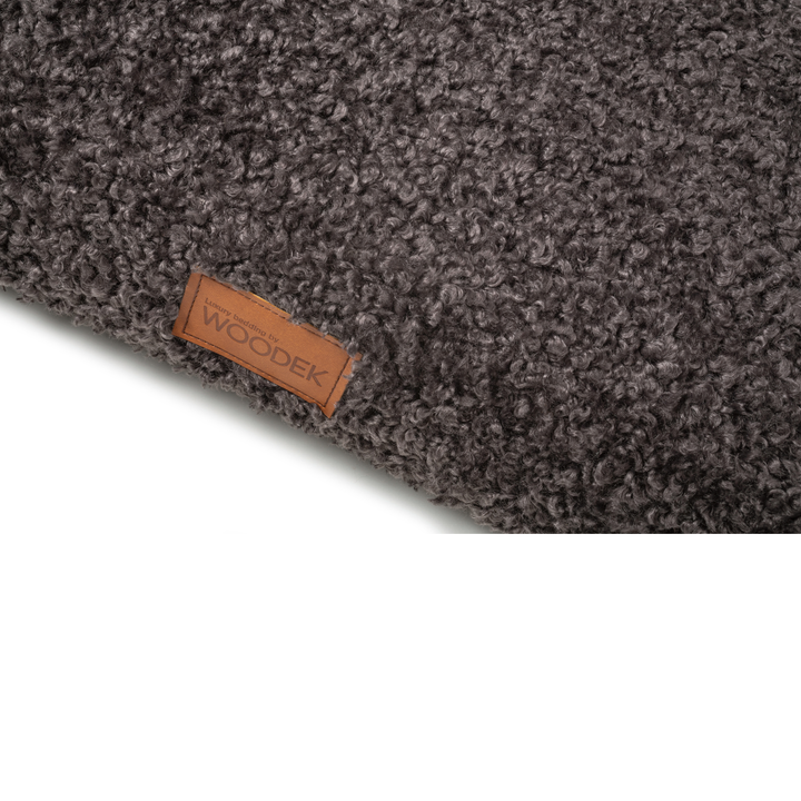 Close-up of the soft textured surface and luxury branding on a gray pet mattress by Woodek.