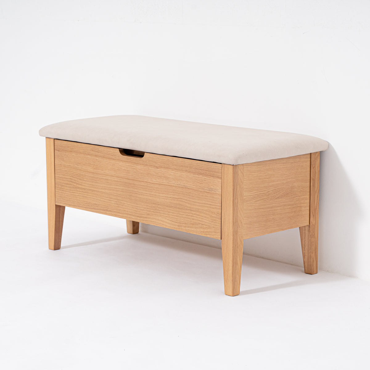Wooden bench with a cream cushion on a white background