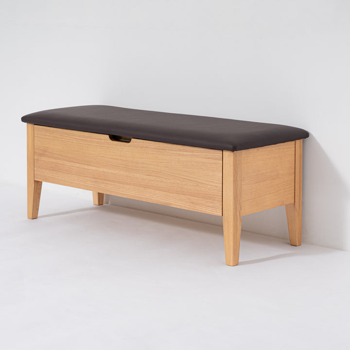 Wooden bench with a dark cushion on a white background