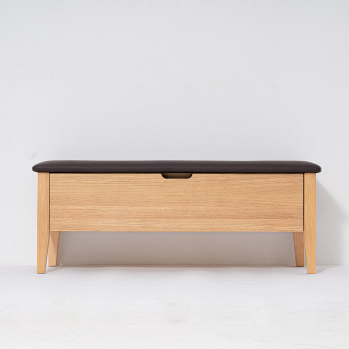 Wooden bench with a black cushion on a white background