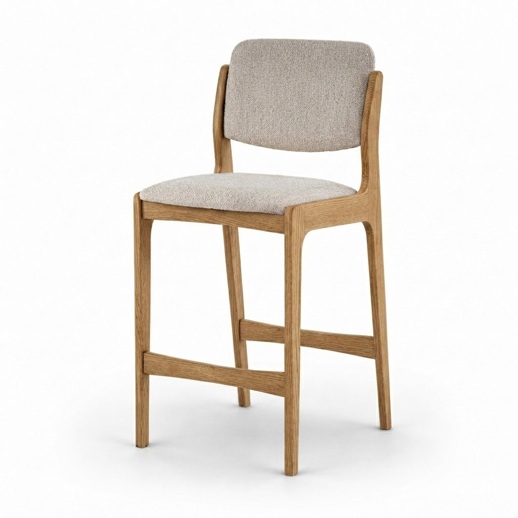 A modern bar stool with a light oak wood frame and a light beige textured fabric seat and backrest, shown on a clean white background.