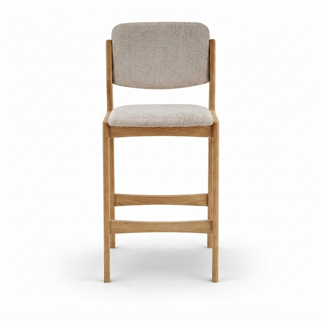 A modern counter stool with a light oak wood frame and light beige textured fabric upholstery on the seat and backrest, shown from a front-facing perspective on a white background.