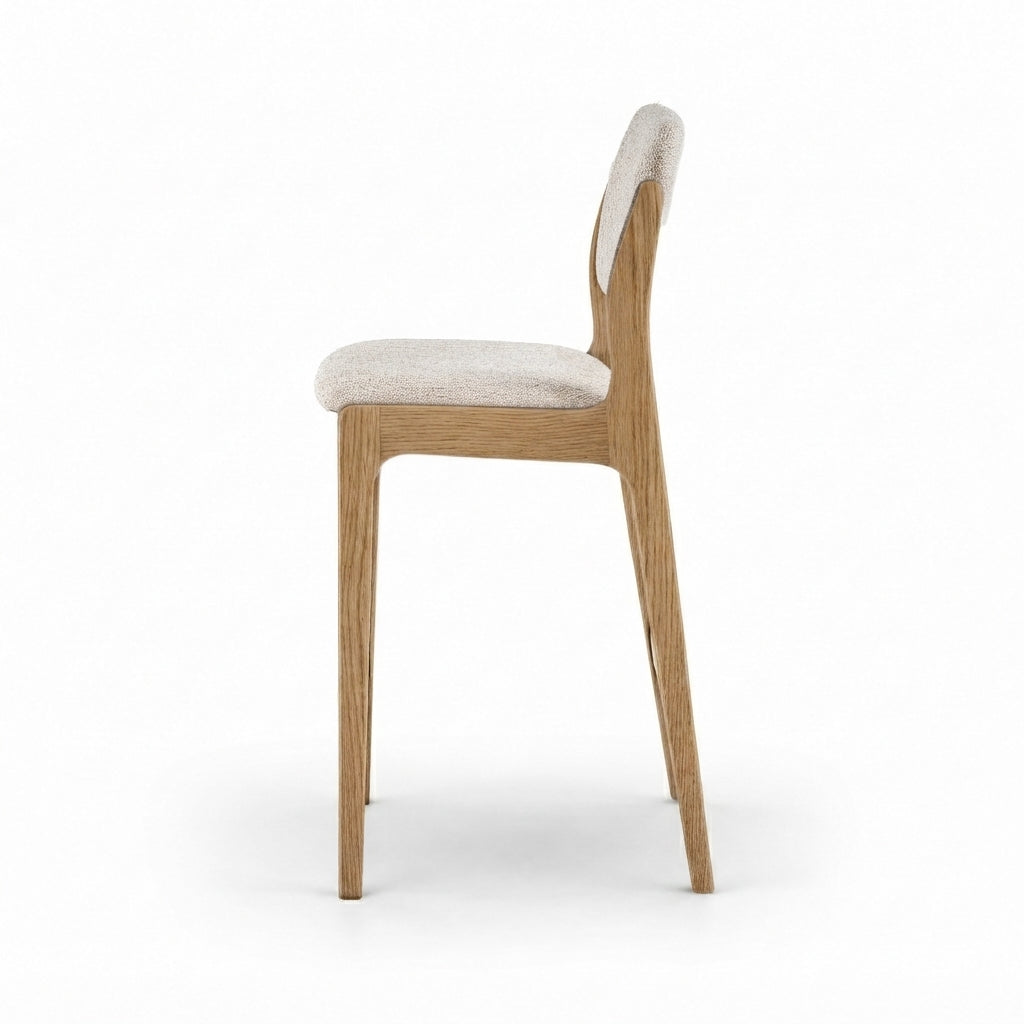 A modern wooden dining chair with a light beige textured fabric seat and backrest, shown from a side profile view against a solid white background.