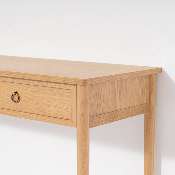 Wooden desk with a single drawer on a white background