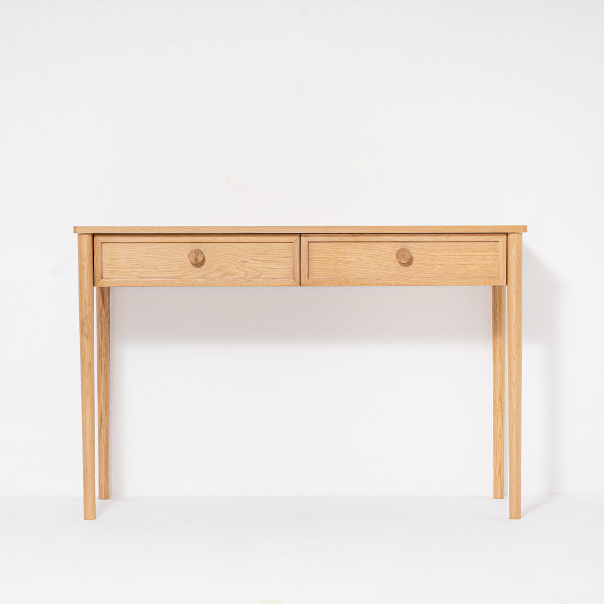 Wooden desk with two drawers on a white background