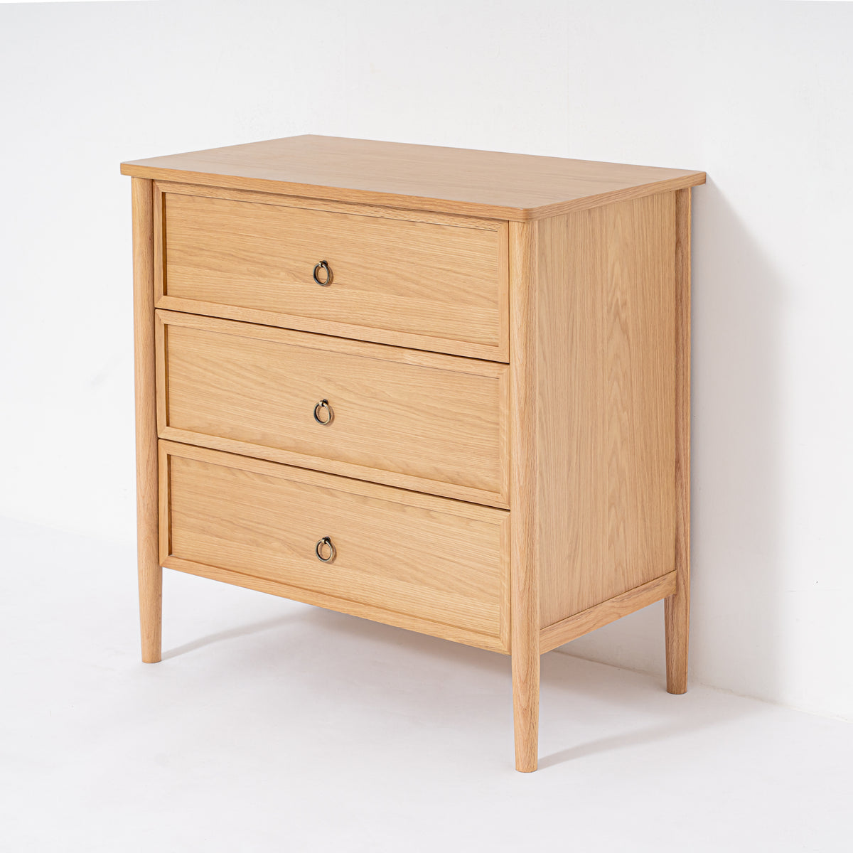 Wooden dresser with three drawers on a white background