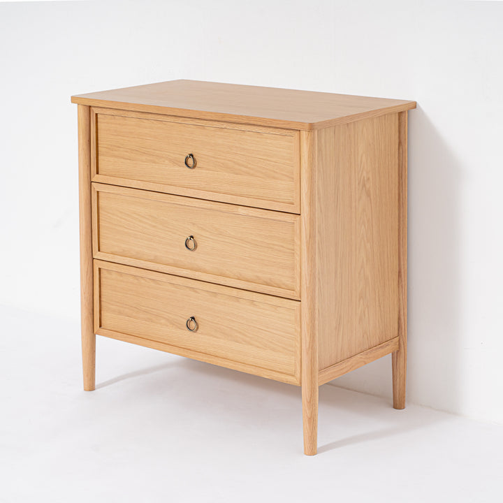 Wooden dresser with three drawers on a white background