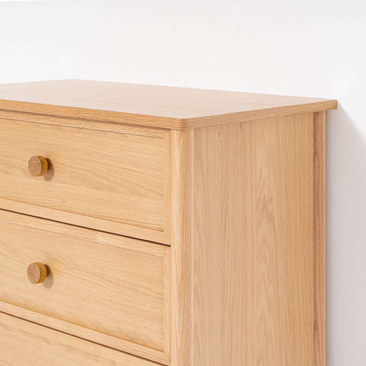 Wooden dresser with three drawers on a white background