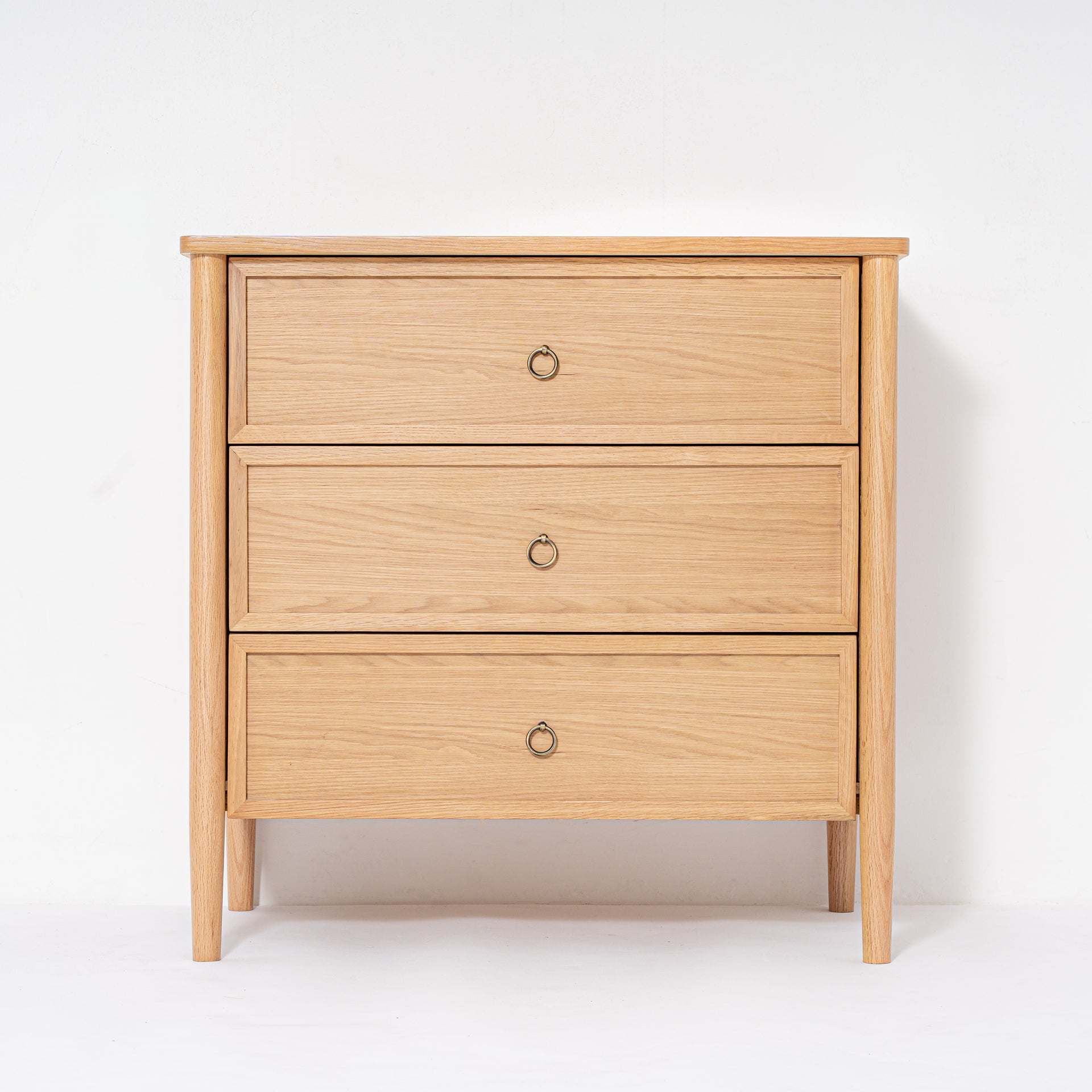 Wooden dresser with three drawers on a white background