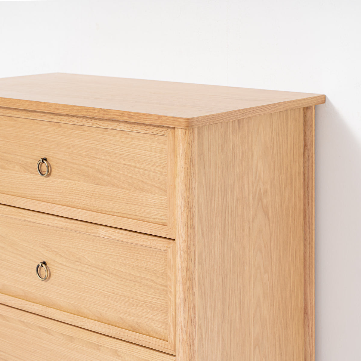 Wooden dresser with three drawers on a white background