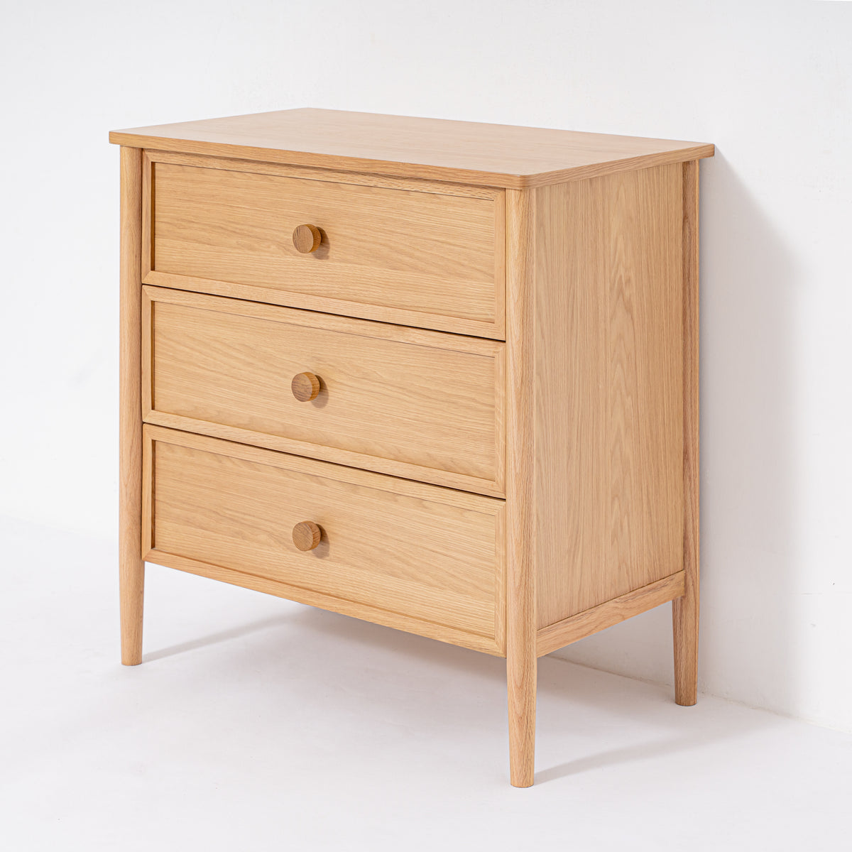 Wooden dresser with three drawers on a white background