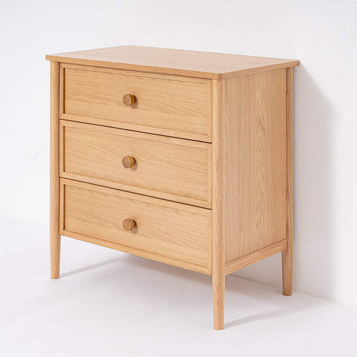 Wooden dresser with three drawers on a white background