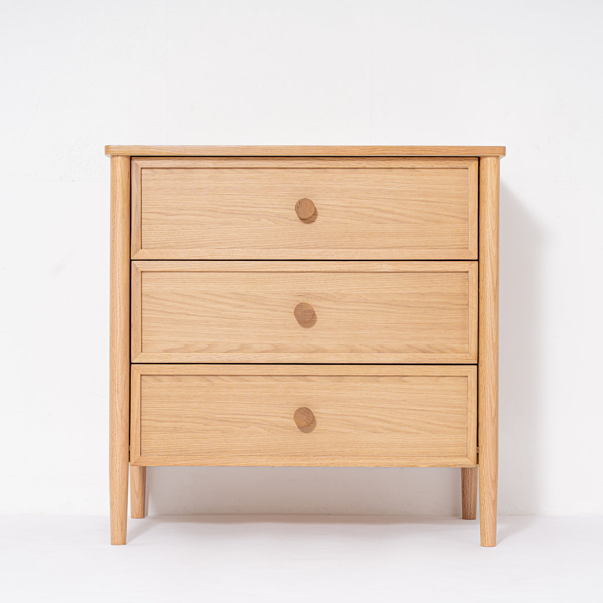 Wooden dresser with three drawers on a white background