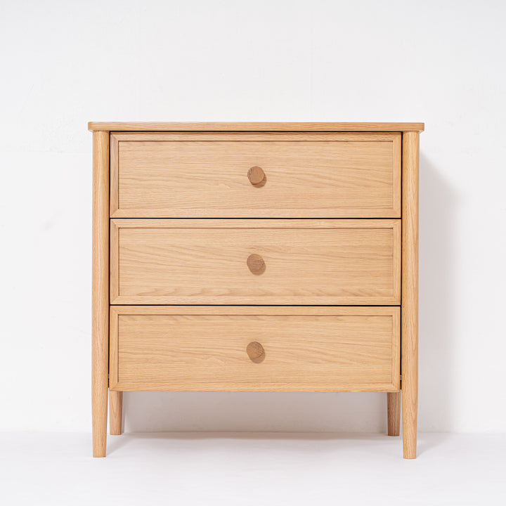 Wooden dresser with three drawers on a white background