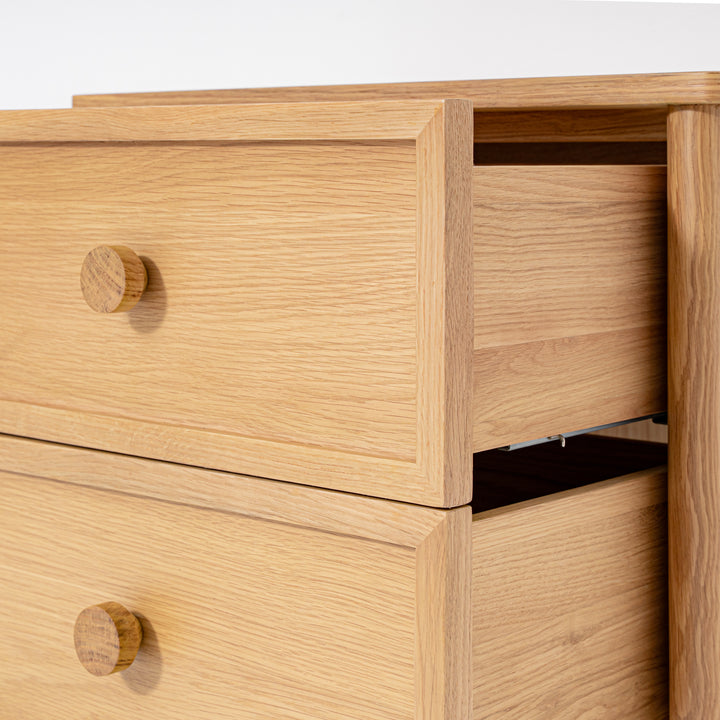 Wooden drawer unit with two visible drawers on a white background