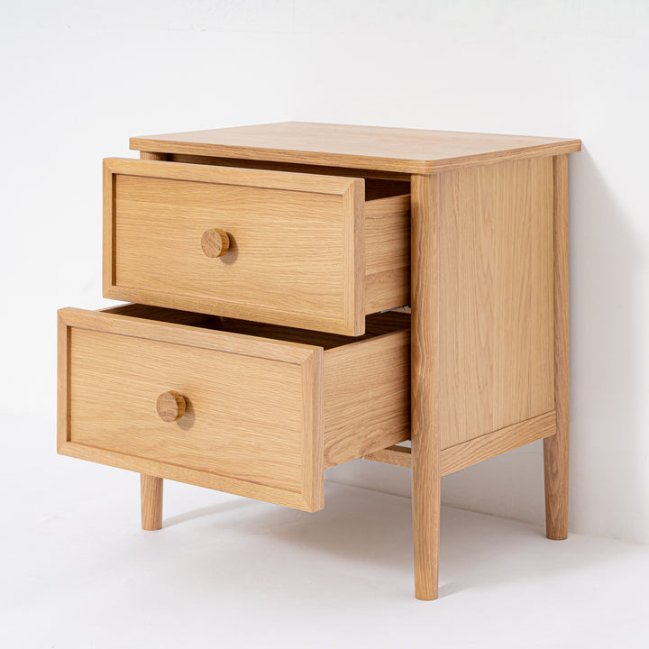 Wooden nightstand with two opened drawers on a white background