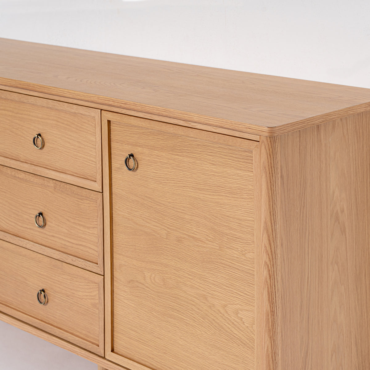 Wooden dresser with drawers and a door on a white background