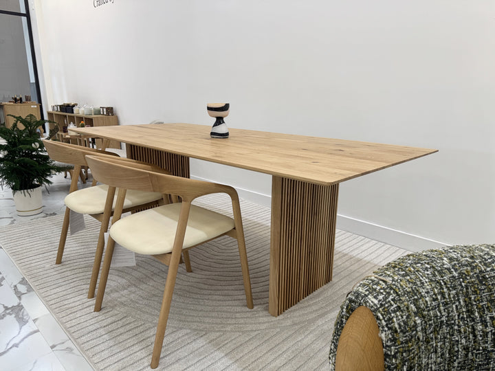 Rustic extendable solid oak table with artisanal craftsmanship and natural finish