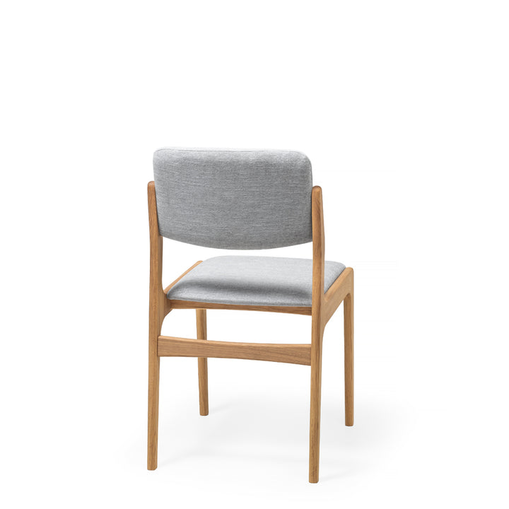 Trendy Scandinavian style oak wood dining chair with seat and backrest upholstered in gray fabric