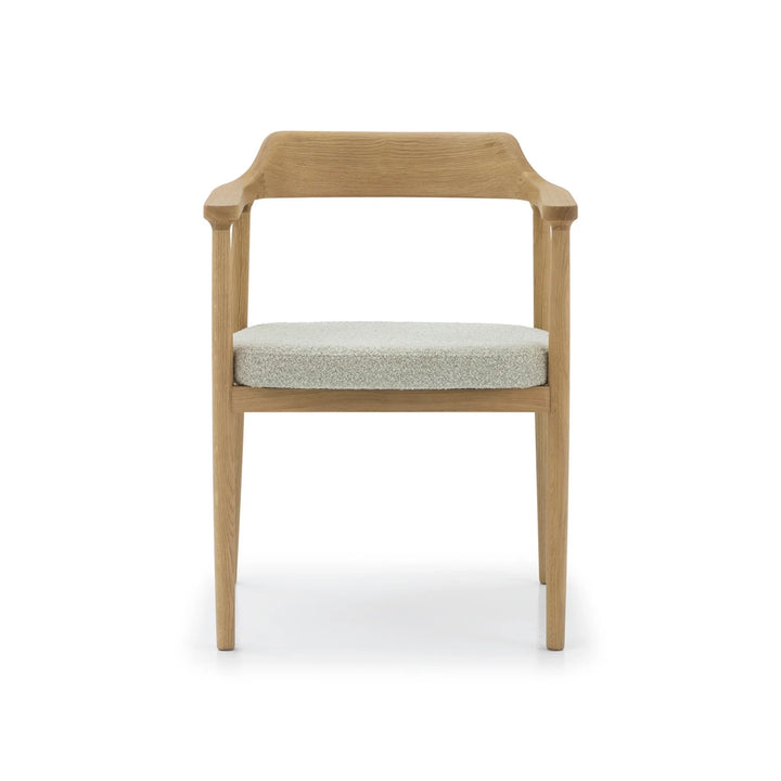 Elegant oak dining chair with slender frame, upholstered seat, and natural wood grain