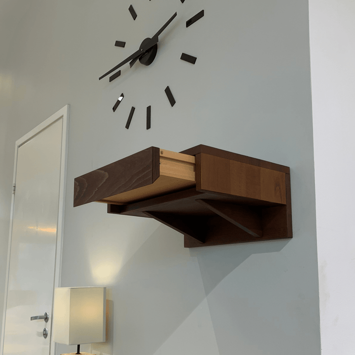 A sleek wooden nightstand attached to the wall, featuring a single drawer with a smooth finish