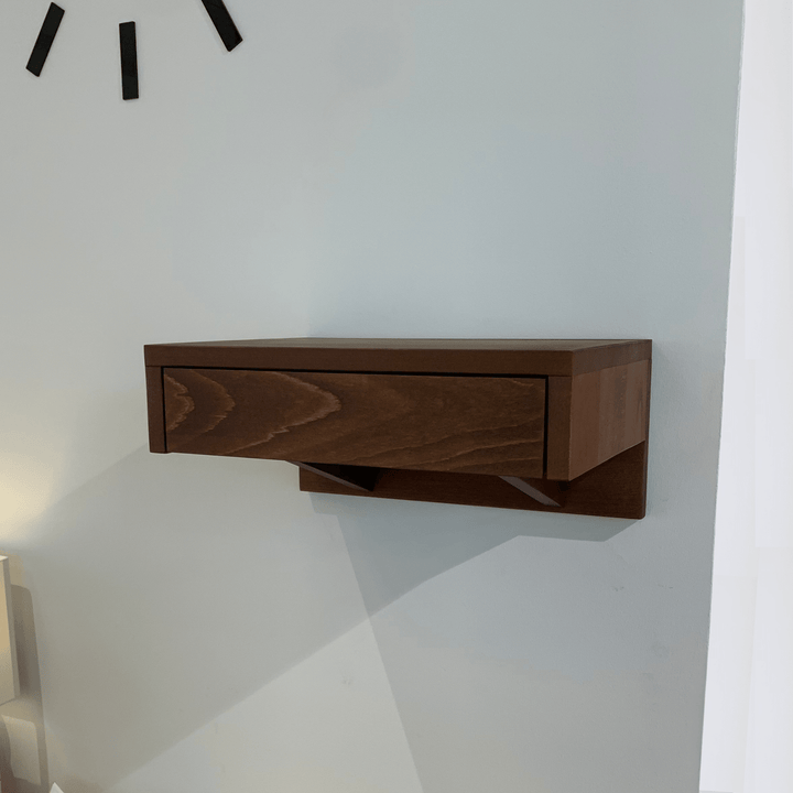 A wooden bedside table featuring a smooth drawer, seamlessly blending with modern bedroom interiors.