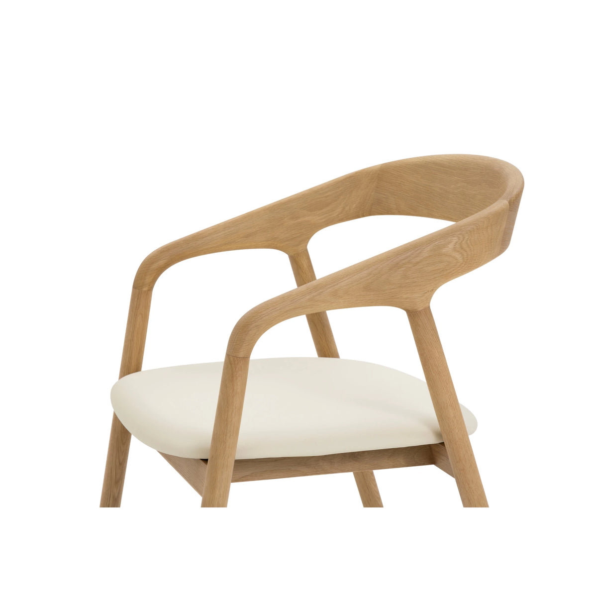 Close-up of Celeste Oak Dining Chair showing wide curved backrest, sculpted armrest fork joint, and smooth beige leather seat