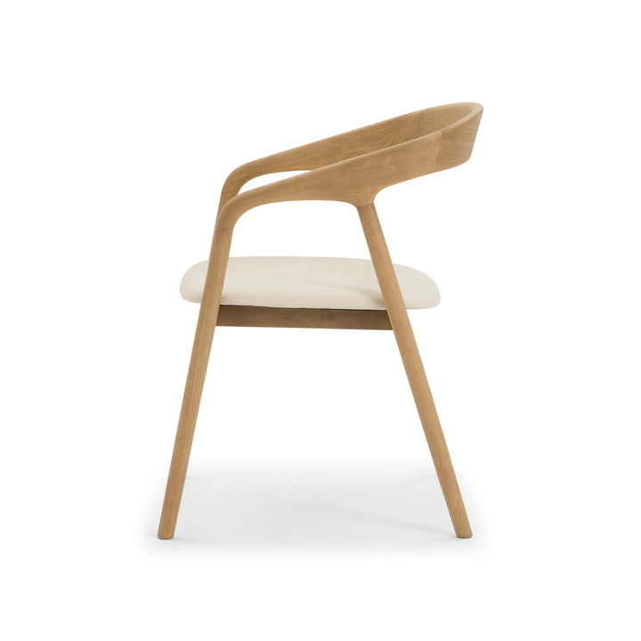 Celeste Oak Dining Chair pure side profile on white background showing curved backrest sweep, sculpted armrest, and legs