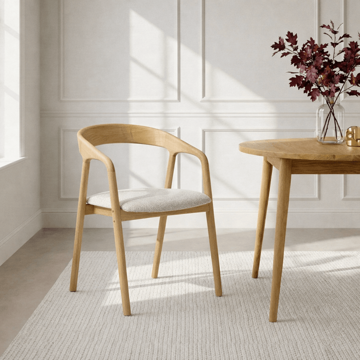 Celeste Oak Dining Chair lifestyle view in a Scandinavian dining room with natural oak frame and off-white Cloud fabric seat