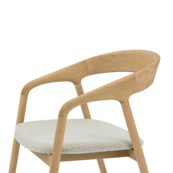 Close-up of Celeste Oak Dining Chair upper frame from above showing curved backrest panel, and off-white Cloud fabric seat
