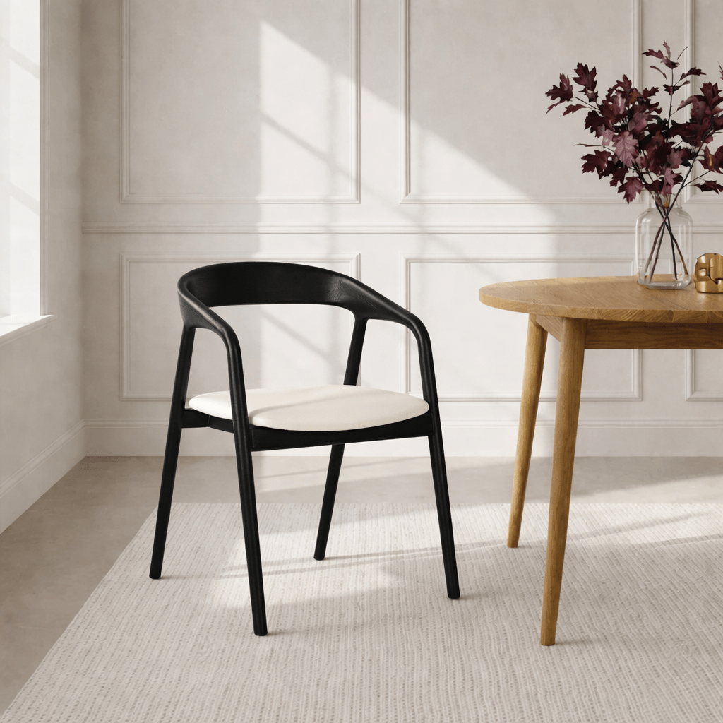 Celeste - Elegant Oak Dining Chair in Black Finish, White Leather with smooth black oak frame and minimalist white leather seat cushion in natural lighting