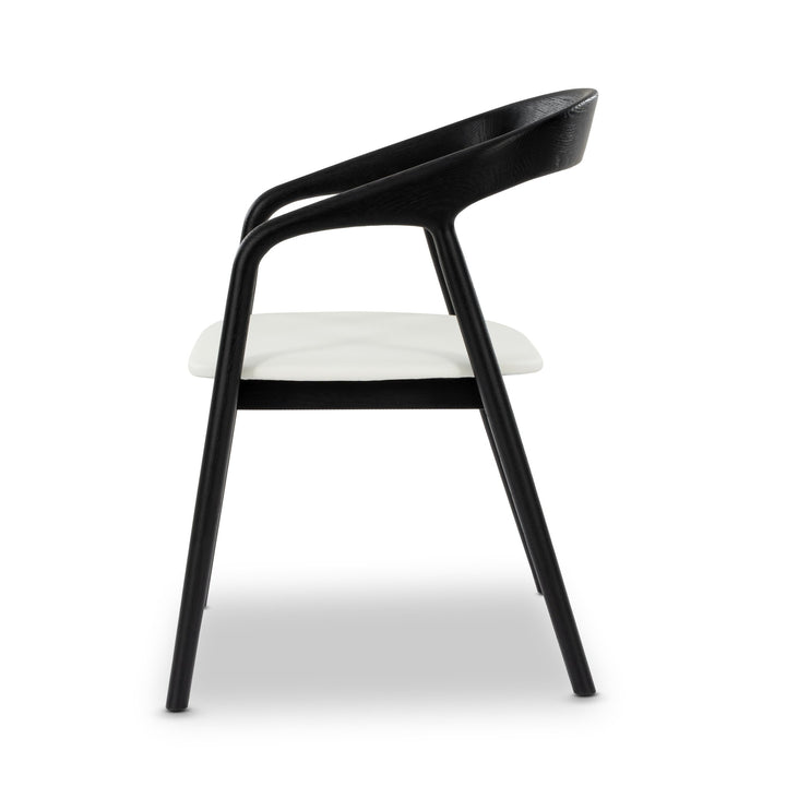 Celeste White Oak Dining Chair - sculpted black oak frame and cushioned white leather seat, side profile view